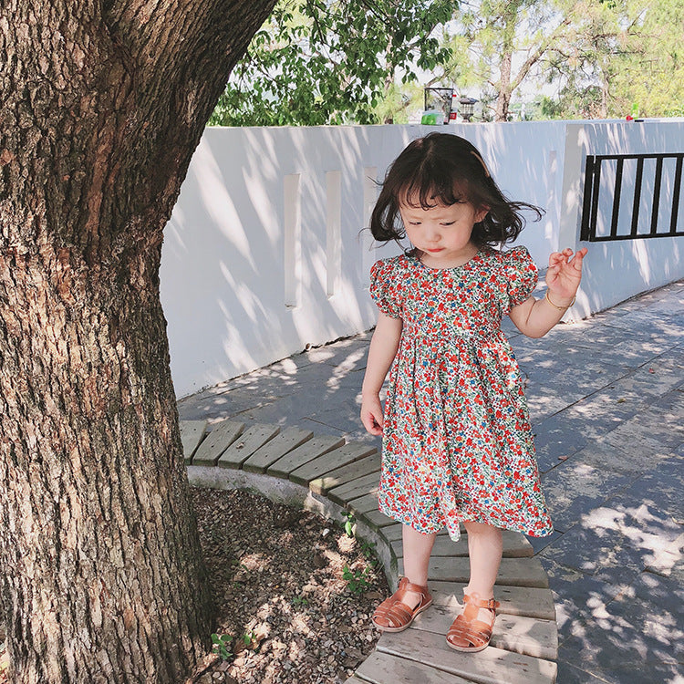 Girls carefully cross the floral dress